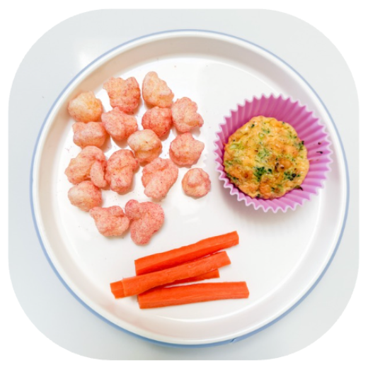 Easy Apple Snack Ideas for babies | Little Bellies AUS White plate with pink-ish snack puffs, carrot sticks, and a small savory muffin in a purple cup on the right side.