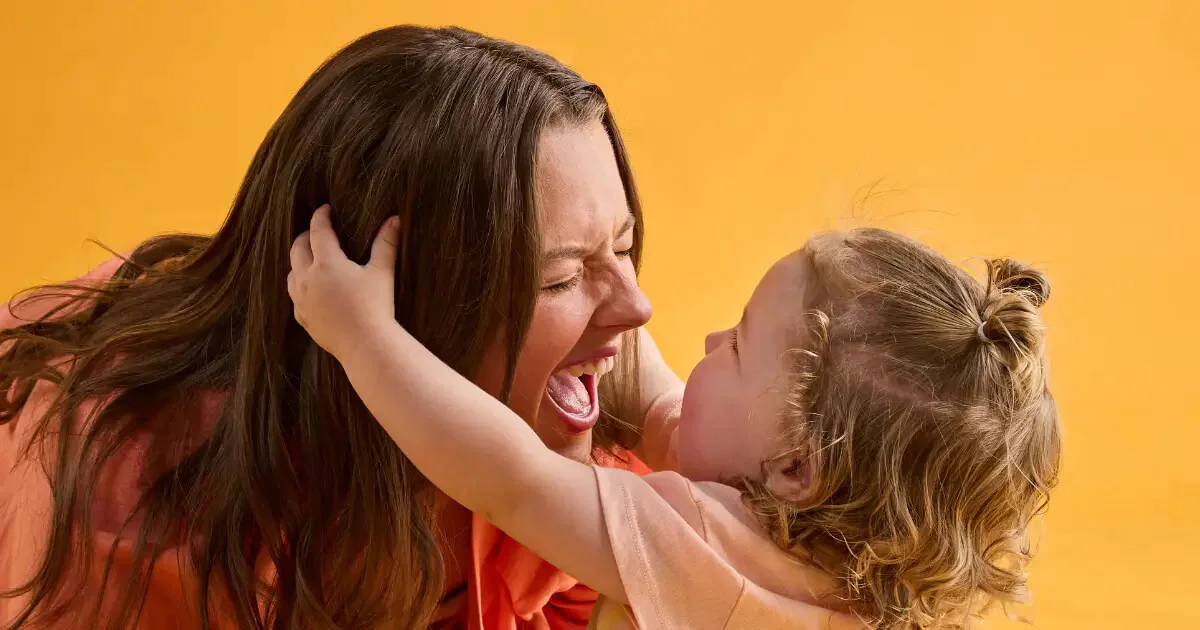 A mother with her daughter pulling at her hair - Little Bellies